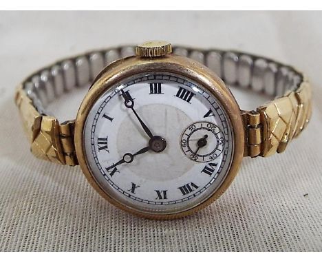 A lady's 9ct yellow gold cased wristwatch with ceramic dial and expanding bracelet
