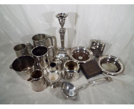 A collection of silver plated tableware to include a Corinthian column candlestick, soup ladle, wine bottle coasters, cigaret