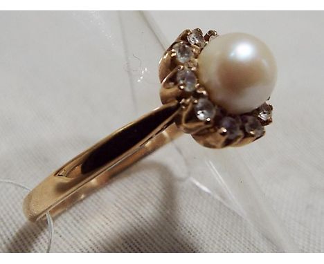 A lady's 9ct yellow gold ring set with large centre pearl and stone set surround, size Q, approximate weight 3.59 grams - Est