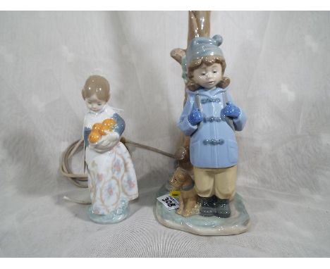 A Lladro figurine entitled Valencia Girl with Oranges, approximately 16cm (h) and a Nao table lamp depicting a girl and puppy