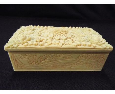 A soap stone trinket box with floral relief decoration, 4cm x 10cm x 5cm
