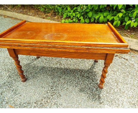 An oak card table with hinged green felt top, raised on barley twist supports, 40cm (h) x 77cm (w) x 43cm (d) opening to 86cm