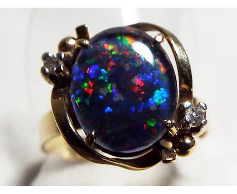 A lady's 9ct yellow gold ring, set with opal and diamond chips, size R, approximate weight 2.99 grams