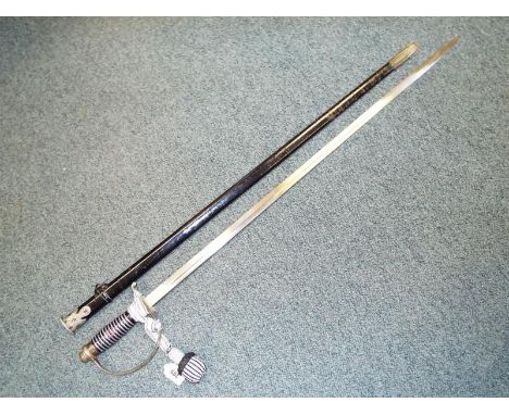 A World War Two (WWII) Third Reich SS officer's dress sword (SS-Degan). With blade marked "Pet.Dan Krebs Solingen". Circa. 19