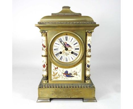 An early 20th century French brass cased mantel clock, the inset panels decorated with birds and flowers, 36cm high