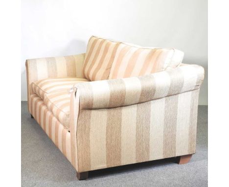 A gold striped upholstered sofa, with loose cushions225w x 100d x 88h cm