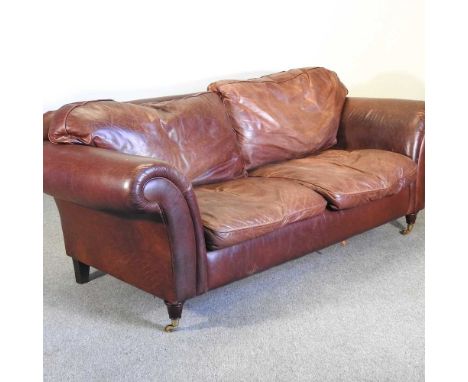 A modern brown leather upholstered sofa, on turned legs229w x 94d x 82h cm