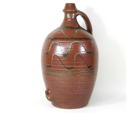 Style of Bernard Leach, an Art pottery ewer, with wavy decoration, 47cm high