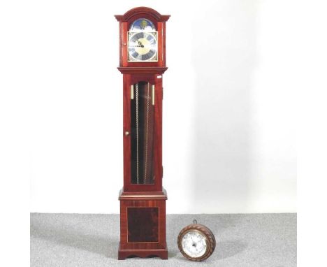 A granddaughter clock, together with an early 20th century aneroid barometer, with a ropetwist surround (2)