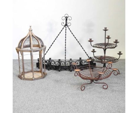 Three iron candlestick holders, together with a birdcage, 64cm high (4)