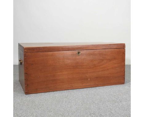A 19th century teak trunk, with a hinged lid and lift out tray, flanked by brass carry handles107w x 60d x 45h cm