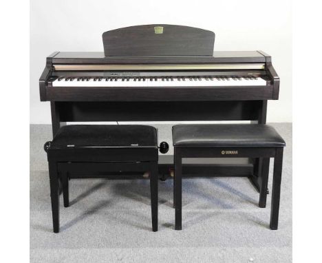 A Yamaha electric Clavinova piano, in an ebonised case, together with two piano stools (3)136w x 48d x 105h cmPlays and opera