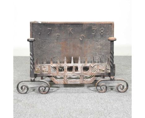 A cast iron fire back, initialled FKS, dated 1738, 74 x 49cm, together with a fire grate and a pair of fire dogs (4)