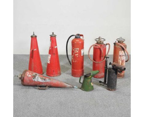 A collection of vintage fire extinguishers, together with a stool