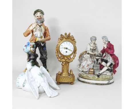 A Dresden style porcelain figure group, together with two others and a continental gilt mantel clock, 26cm high (4)