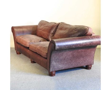 A large brown leather upholstered sofa, on turned feet249w x 97d x 75h cm