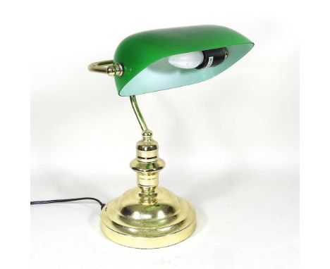 A brass desk lamp, with an adjustable green glass shade, 40cm high