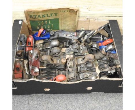 A collection of tools, to include woodworking planes and a Stanley tool guide