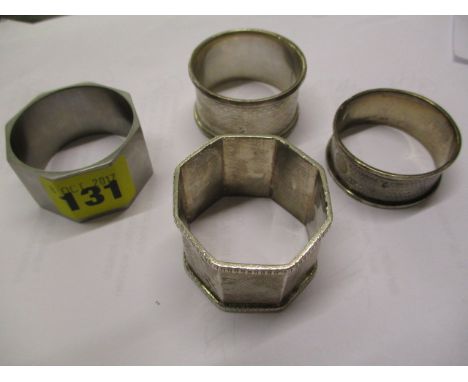 Three silver napkins ring and one other