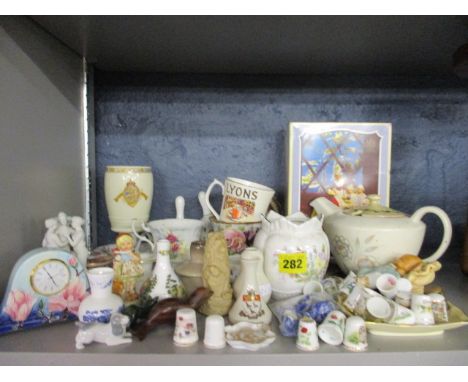 An Old Tuptonware mantle clock, a quantity of china thimbles, mixed china ornaments and a jade cat