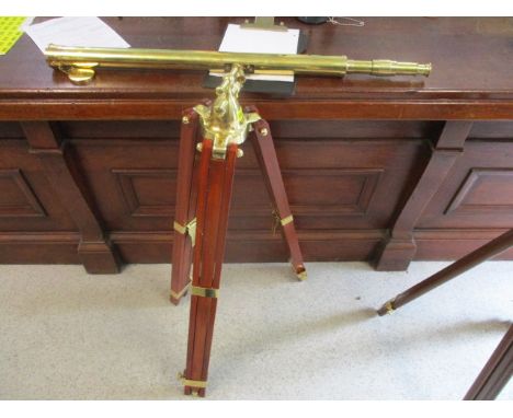 A modern brass telescope on a stained hardwood tripod stand, 35 stand