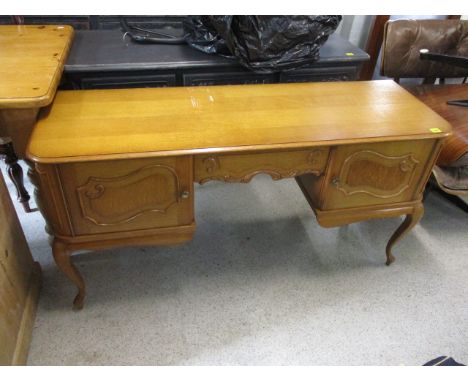 A modern light oak French desk having a single drawer between two cupboards, 27 1/2 h x 53 1/2 w