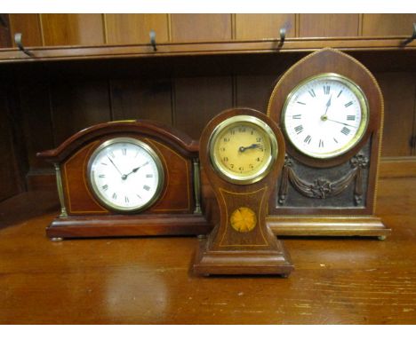 A group of three Edwardian inlaid mahogany cased mantle clocks to include a small balloon shaped clock