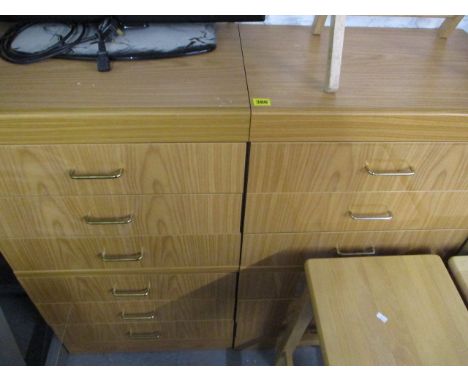 A pair of modern light wood finished chest of six drawers