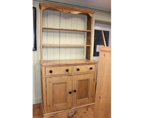 Waxed pine dresser having open shelf back above two drawers with two cupboard doors below, 114cm by 122cm by 48cm.