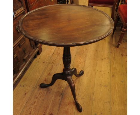 A 19th century mahogany tilt top tripod table, raised on a turned column terminating in three outswept legs, height 29ins