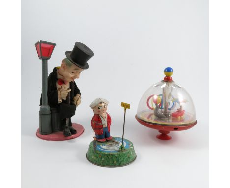 A Japanese tinplate toy, of a man wearing a black evening suit and top hat, with celluloid head, holding a cigar and hip flas