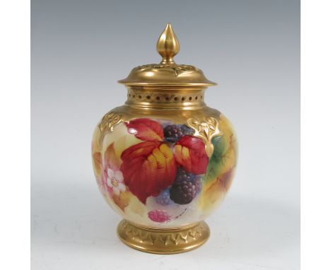 A covered Royal Worcester vase, with gilt pierced cover, the quarter lobed body decorated to the front with autumnal fruits a