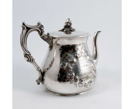 A Victorian silver tea pot, with flower bud finial, the body embossed to one side with grape vine, wheatheaves and tools, the