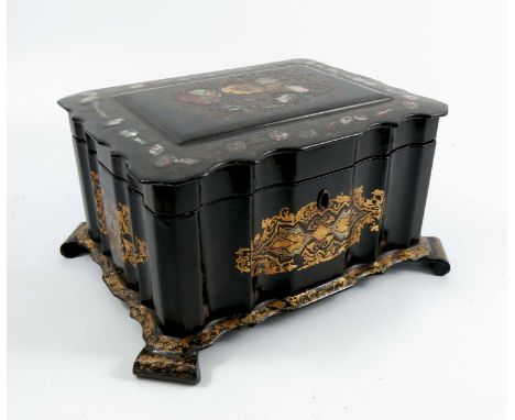A 19th century black papier mache tea caddy, of shaped rectangular form, the exterior decorated in gilt and inlaid mother of 
