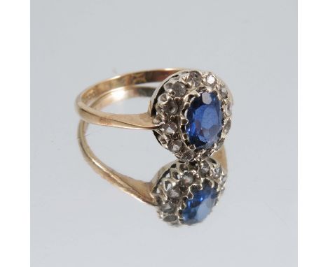 A 9ct gold cluster ring, set with a sapphire surrounded by diamonds