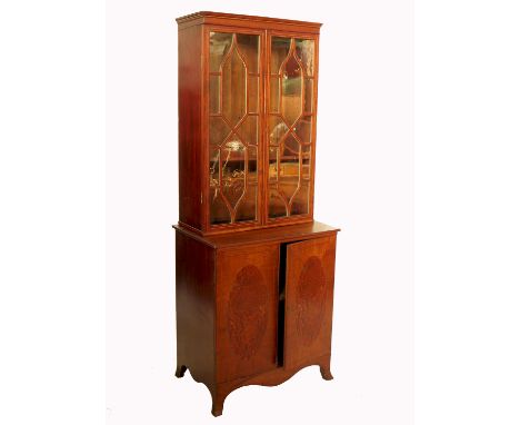 A mahogany two door cabinet, with glazed upper section, the base with inlaid panels to the doors, fitted with a shelf, raised