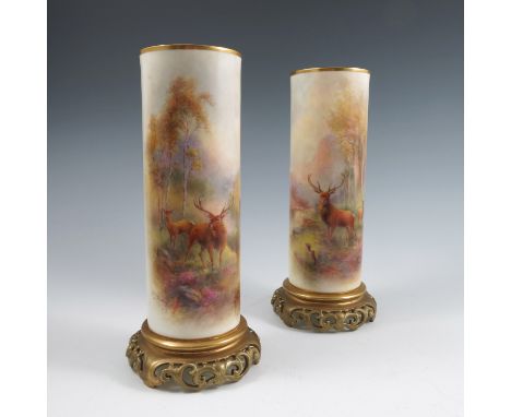 A pair of Royal Worcester vases, of cylindrical form, decorated with Stags in landscape by Harry Stinton, on pierced gilt bas