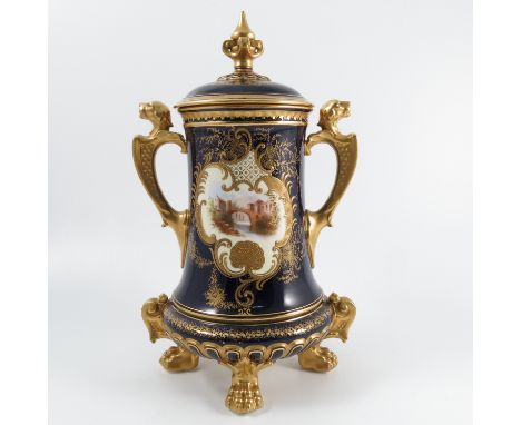 A Coalport covered vase, the scroll framed cartouche decorated with a continental town scene, the back with small cartouche, 