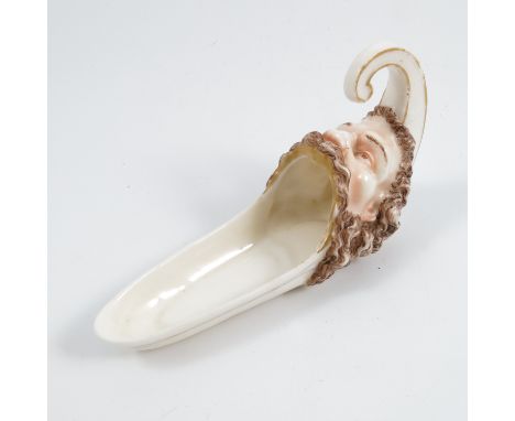 A 19th century Royal Worcester cigar holder, formed as a bearded man with gaping mouth, dated 1866, length 6.25insCondition R