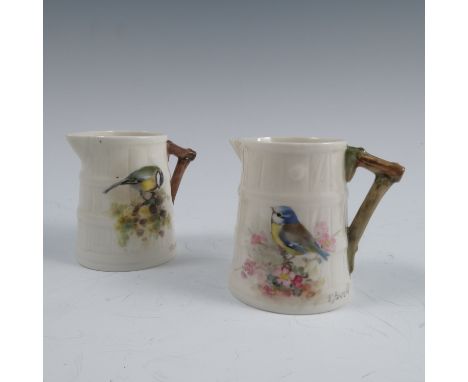 Two Royal Worcester barrel moulded jugs, painted with a Blue Tit and a Great Tit on foliage by W Powell, dated 1921 and 1932,