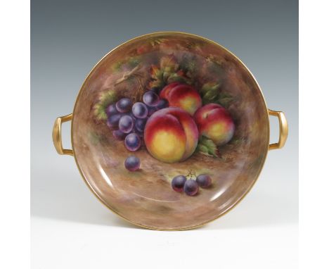 An English porcelain circular bowl, the interior painted with fruit to a mossy background by R Budd, with a pair of gilt hand