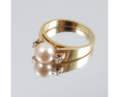 A cultured pearl ring, stamped '18ct', the 7mm diameter pearl with a small brilliant cut diamond to each shoulder, finger siz