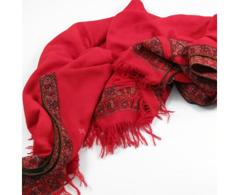 Three ladies' shawls, a red ground shawl with paisley decoration, an elaborate stitched shawl decorated with brightly coloure