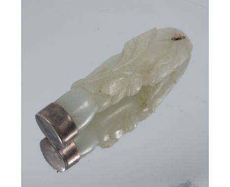 A carved jade brooch, with white metal unmarked mount, 6.6cm long