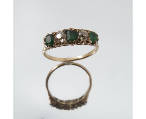 A diamond and emerald five stone ring, unmarked, the two old brilliant cuts totalling approximately 0.4 carats, finger size Q