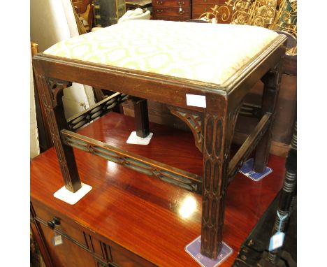 An oak Chippendale design stool, of rectangular form, with drop in seat, raised on carved legs with pierced stretchers, 20.5i