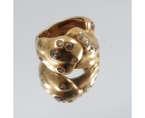 A fifteen stone diamond set ring, unmarked, the old cut diamonds totalling approximately 0.6 carats, random set to an abstrac