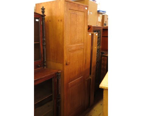 A Peter Waals oak single door wardrobe, from Loughborough University, with triple panel door, fitted with a shelf and hanging