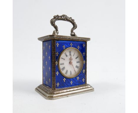 A French miniature enamelled clock, of rectangular form, with scroll handle to top, the silver case with blue enamel and gilt