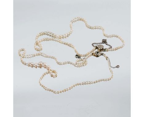 A string of seed pearls, the diamond set flower head clasp marked 18ct and Plat, together with another string of pearls, the 